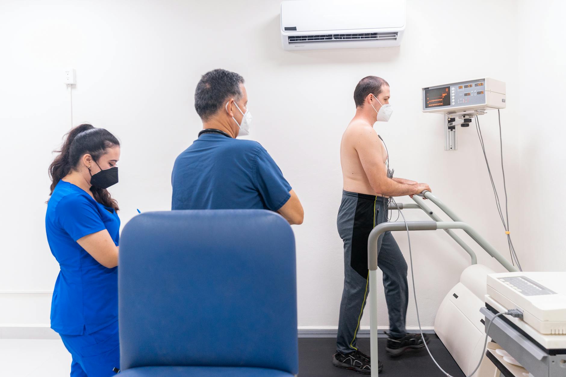 a cardiologist examining a patient undergoing cardiac stress test