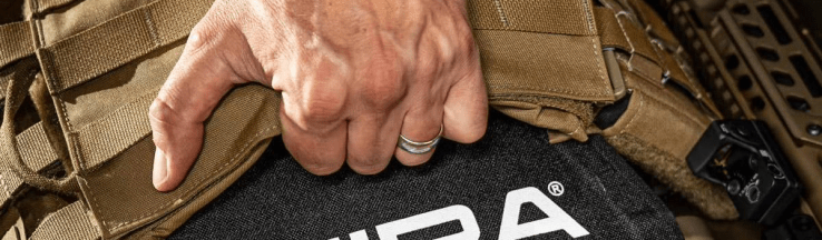 Hand inserting MIRA tactical armour plate.